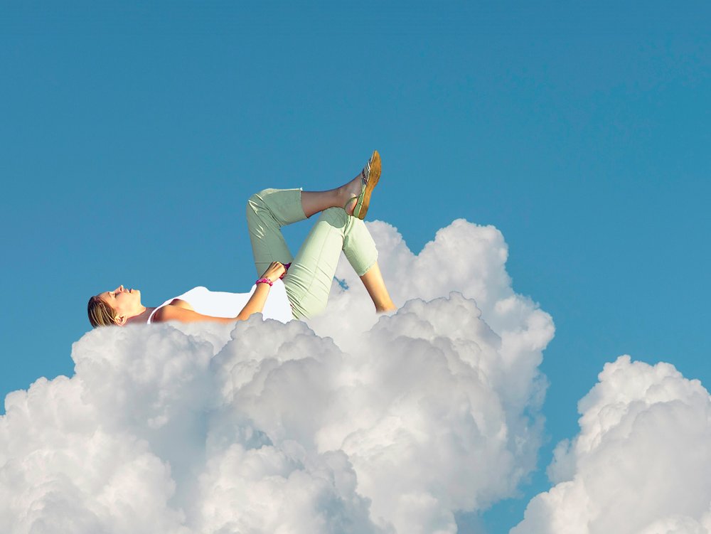 Personne allongée et détendue sur un nuage, symbole de légèreté